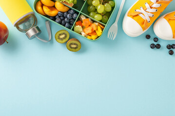 Nourish your brain: Top-down view of sneakers, a lunch box packed with sandwiches, fruits, vegetables, and a water bottle on a pastel blue isolated backdrop, ready for text or promotional content