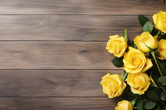 Yellow roses on a wooden background. Floral frame composition. Empty space, flat lay, top view