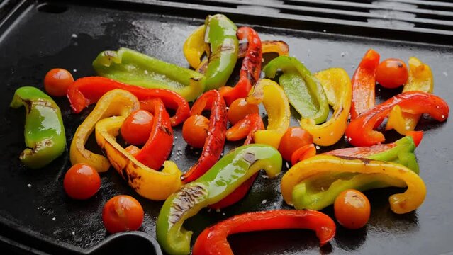 Green Yellow Red Bell Pepper Cut Pieces,Tomato On Grill platte Falling Spices, Slow Motion, Close Up