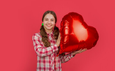happy teen girl hold love heart balloon on red background