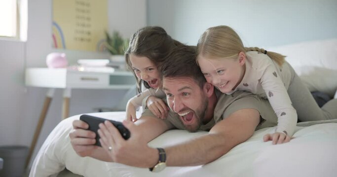 Crazy, face and selfie with dad and children, girls or family with funny, silly or joke photo for social media or profile picture. Father, kids or relax in morning and together on bed. phone and home