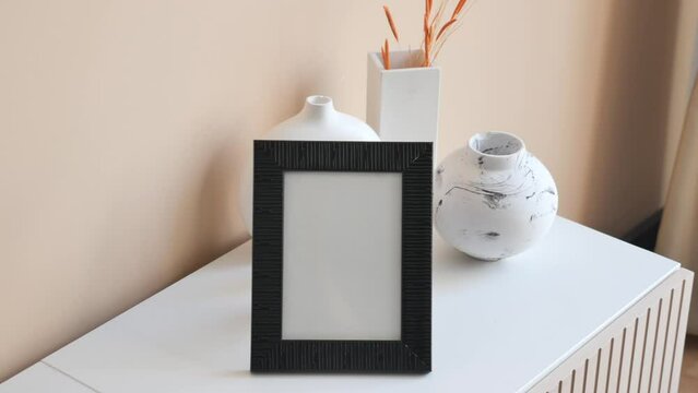empty frame on TV cabinet in front of the empty clean wall