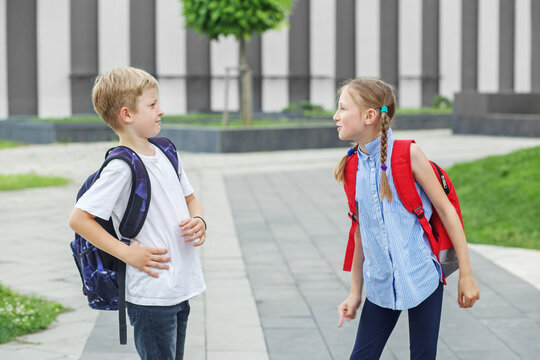 Two children, classmates, quarrel and yell on way from school. Conflict and negative emotion.