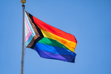 Close-up of Rainbow flag (LGBT movement) waving in the wind. 