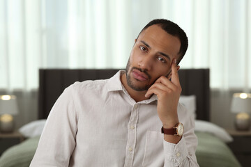 Bored man having online video call at home, view from camera