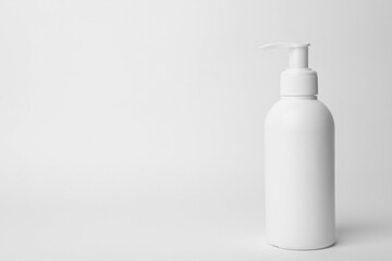Bottle of face cleansing product on white background. Space for text