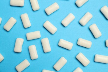 White bubble gums on blue background, flat lay