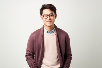 Young Asian man with eyeglasses on white background. Studio shot.