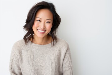 Portrait of happy asian woman smiling at camera on white background
