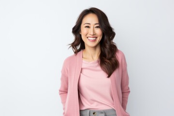 Fototapeta premium Portrait of a smiling young businesswoman looking at camera over white background