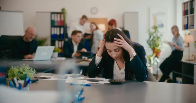 Worried businesswoman with documents in office.