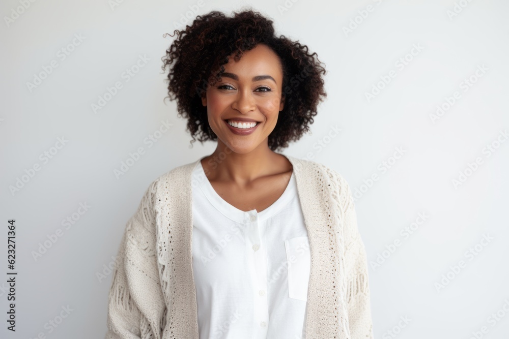 Wall mural portrait of a smiling young african american woman standing against white background