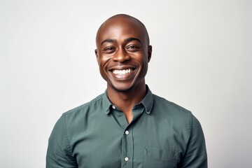 Fototapeta premium Portrait of a smiling african american man standing over white background