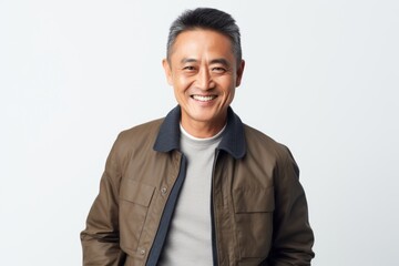 Portrait of a smiling asian man in casual clothes standing against white background