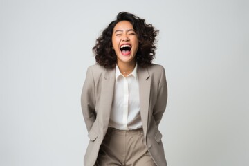 excited african american businesswoman with curly hair screaming isolated on grey