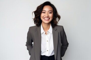 Portrait of a smiling asian businesswoman posing isolated over white background