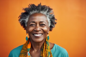 Portrait of a smiling african american woman on orange background