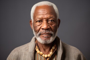 Portrait of a senior african american man on grey background