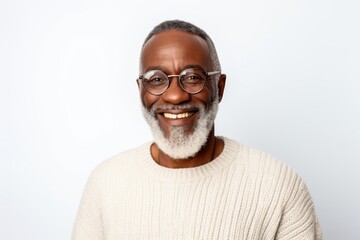 Handsome mature African American man in glasses smiling at camera while standing against white background