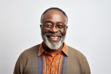 Fototapeta premium Portrait of a smiling senior African-American man wearing glasses, standing against white background