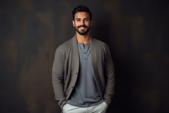 Lifestyle portrait photography of a satisfied Saudi Arabian man in his 30s wearing a chic cardigan against an abstract background 