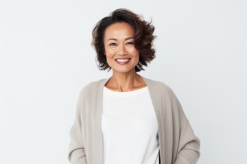 Fototapeta premium Portrait of a smiling businesswoman standing with hands on hip over white background