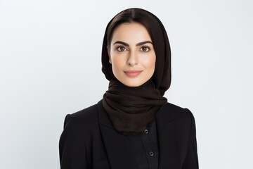 Portrait of beautiful muslim woman in hijab looking at camera over white background