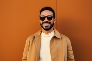 Fototapeta premium smiling african american man in sunglasses looking at camera isolated on orange