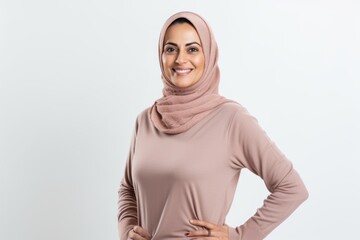 Portrait of muslim woman in hijab smiling at camera on white background