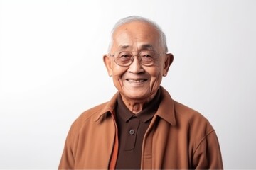 Obraz premium Portrait of a senior asian man smiling on white background.