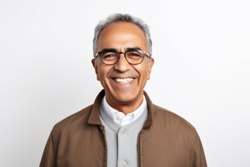 Portrait of happy senior Indian man in eyeglasses smiling at camera