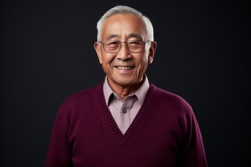 Obraz premium Portrait of senior asian man looking at camera on black background