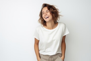 Fototapeta premium Portrait of a happy young woman laughing isolated on a white background