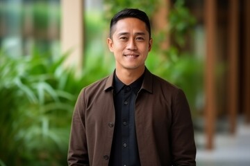Obraz premium Portrait of a young handsome asian man smiling at the camera