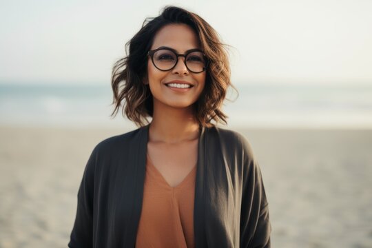 Lifestyle portrait photography of a pleased Saudi Arabian woman in her 40s wearing a chic cardigan against a beach background 