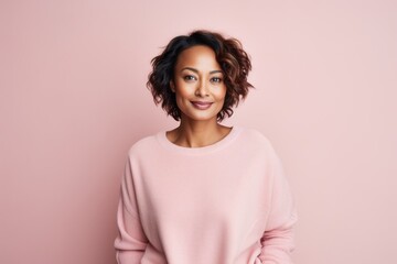 Portrait of a beautiful young african american woman on a pink background