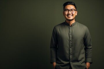 Obraz premium Young handsome Indian man against gray background. Asian man wearing glasses.