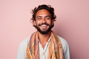 Obraz premium Portrait of a handsome young man smiling at the camera while standing against pink background