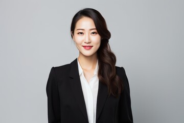 Portrait of young asian business woman smiling and looking at camera