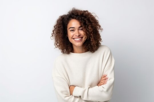 Medium shot portrait photography of a pleased Brazilian woman in her 30s wearing a cozy sweater against a white background 