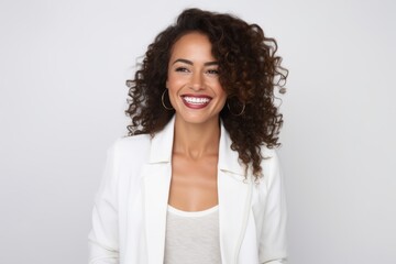 Portrait of smiling young woman with curly hair, isolated on white background