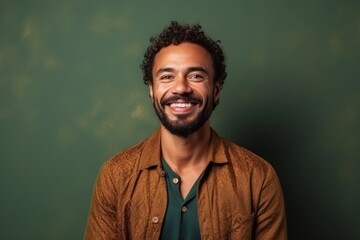 Portrait of a smiling african american man standing against green wall