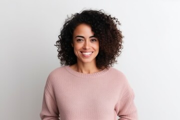 Fototapeta premium Portrait of a beautiful young woman with curly hair standing against white background