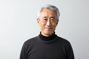 Portrait of a senior asian man looking at camera on white background