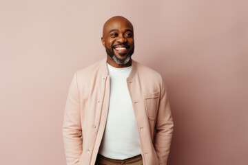 Obraz premium smiling african american man in beige jacket on pink background