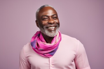 Obraz premium Portrait of a smiling senior african american man wearing pink scarf