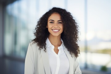 Portrait of beautiful young businesswoman smiling at camera in the office