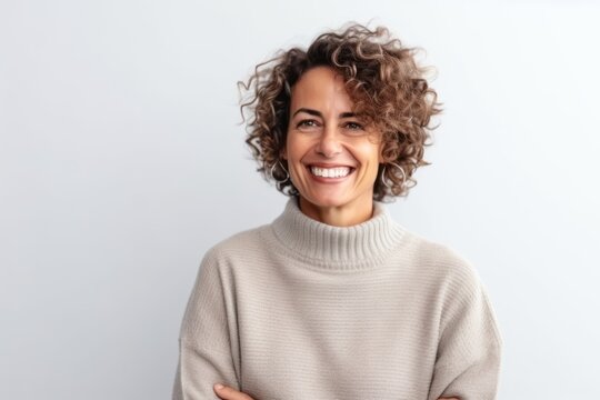 Medium shot portrait photography of a pleased Brazilian woman in her 40s wearing a cozy sweater against a white background 