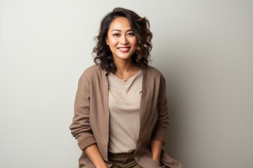 Fototapeta premium Portrait of a beautiful young asian woman smiling and looking at camera