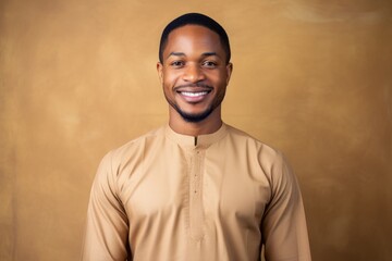 Medium shot portrait photography of a happy Nigerian man in his 30s wearing a simple tunic against an abstract background 